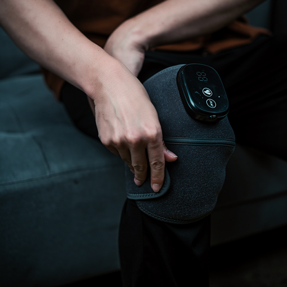 Knee Recovery Wrap worn on the knee while seated, control panel facing out